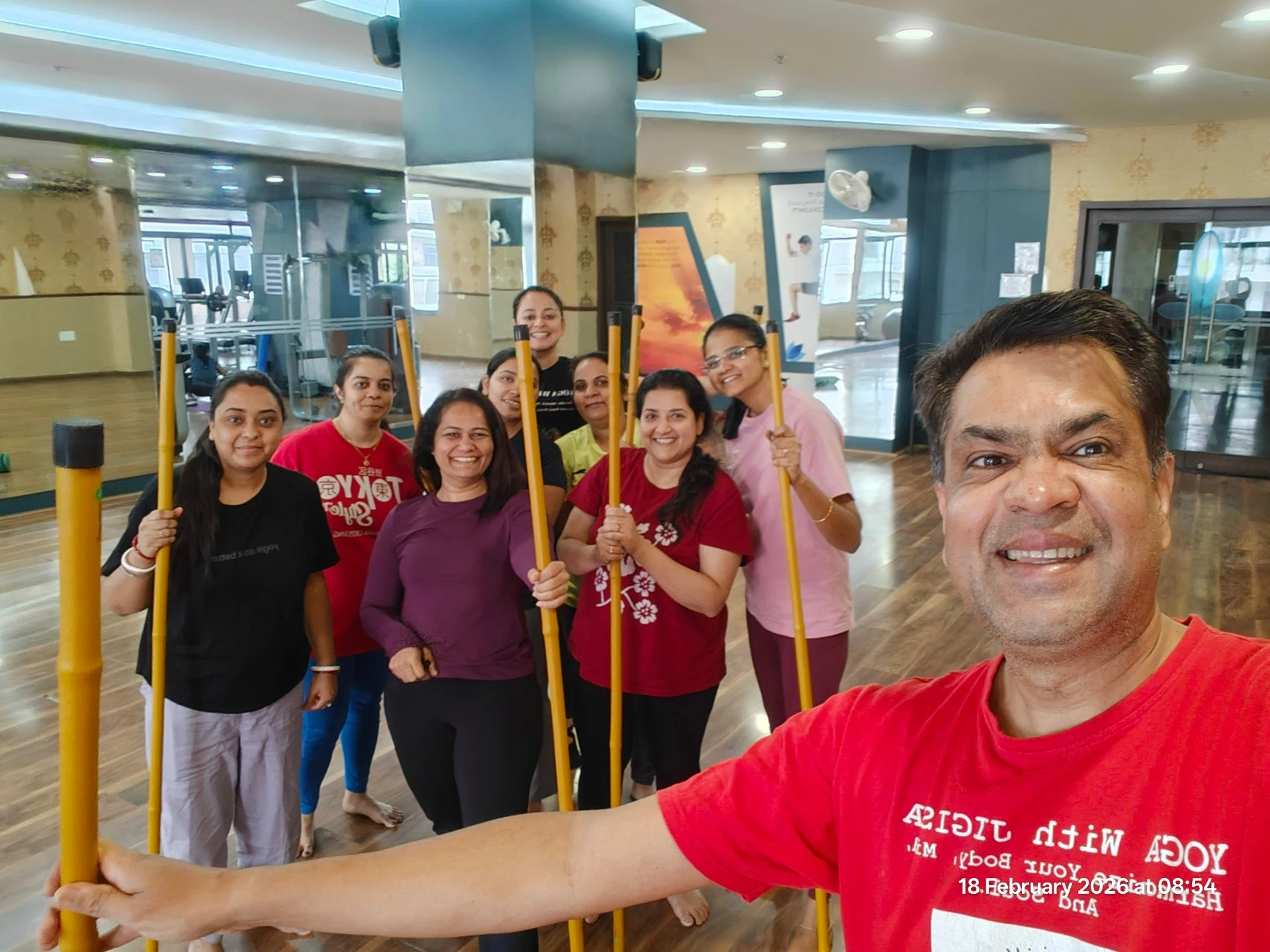 Stick Yoga Group Session - Jigisha and students with yoga sticks in fun group selfie at Yoga With Jigisha Bangalore
