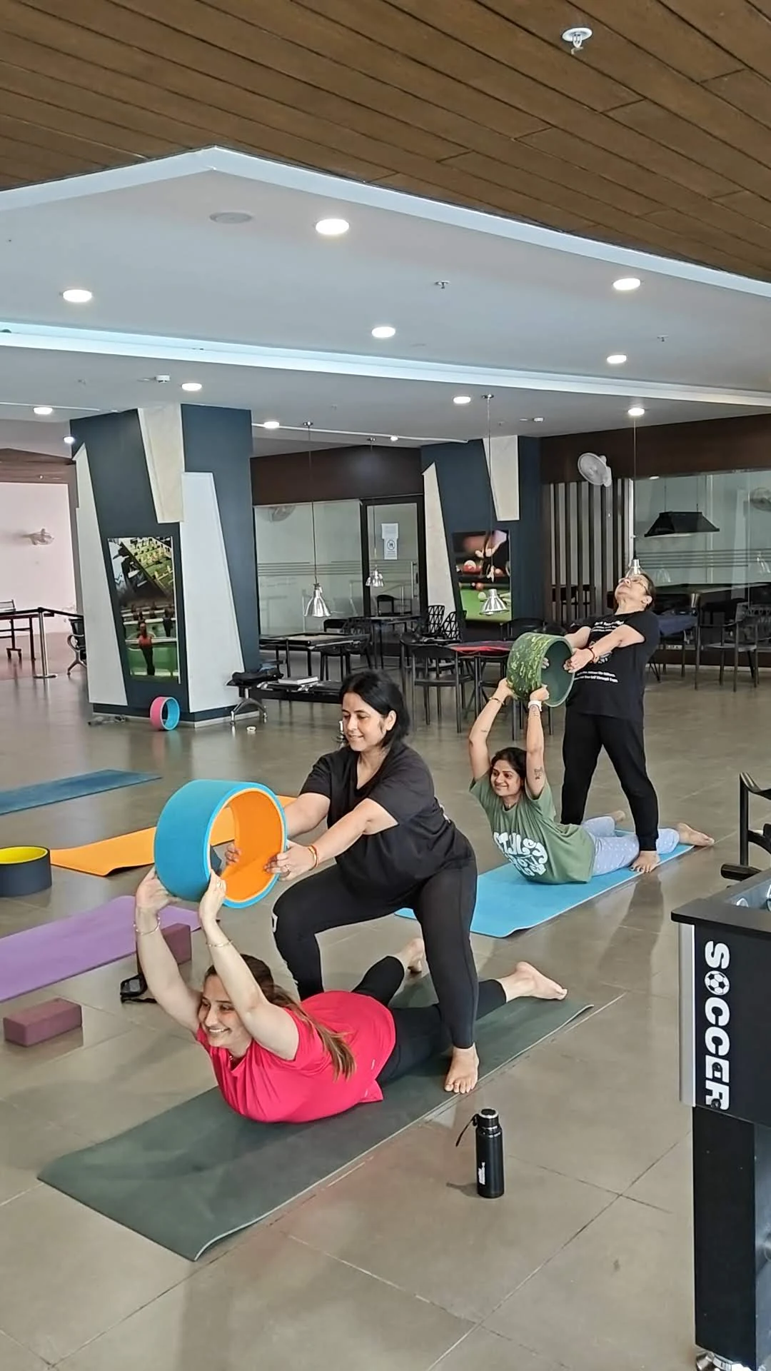 Wheel Yoga Bhujangasana Practice - Students performing cobra pose with yoga wheels at Yoga With Jigisha Bangalore