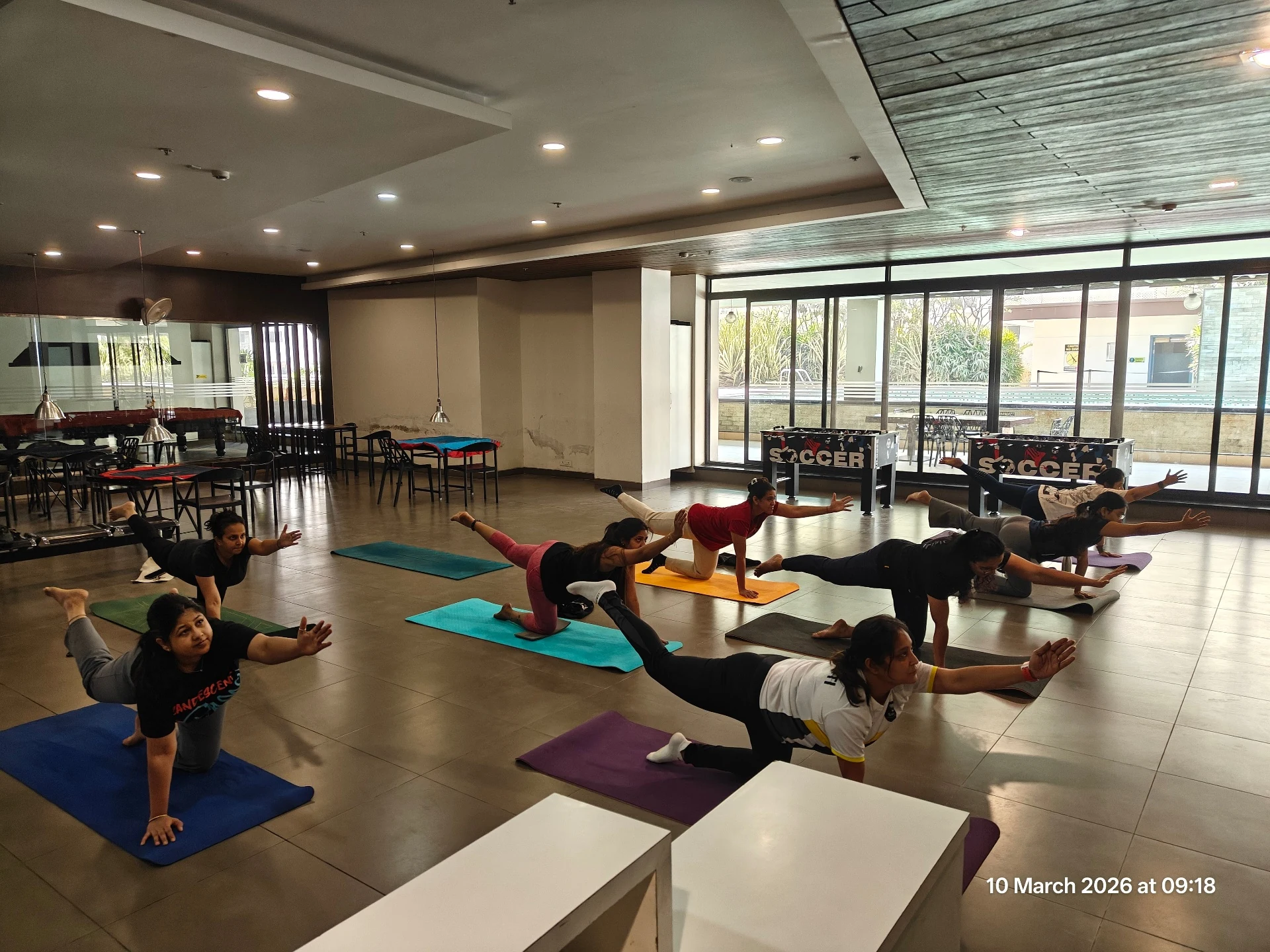 Wheel Yoga Session - Group balancing practice with bird dog pose at Yoga With Jigisha Bangalore March 2026