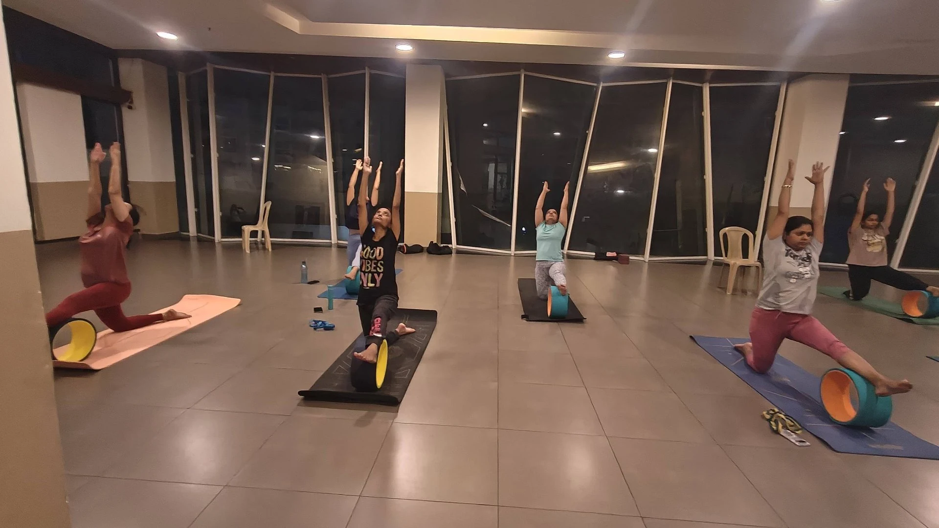 Evening Wheel Yoga Practice - Community practice under studio lights