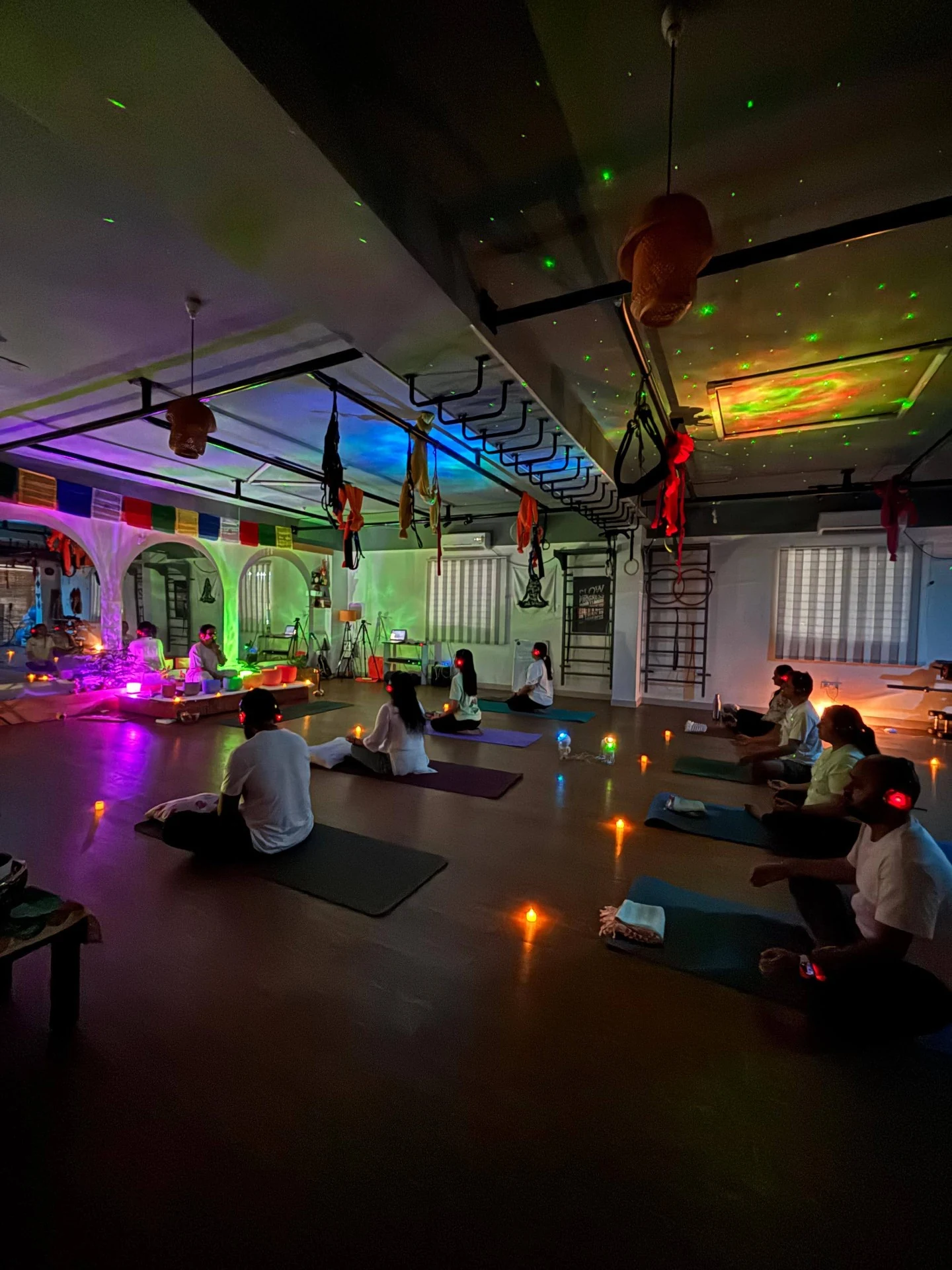 Immersive Sound Healing event with galaxy lighting candles and headphones at Yoga With Jigisha Bangalore