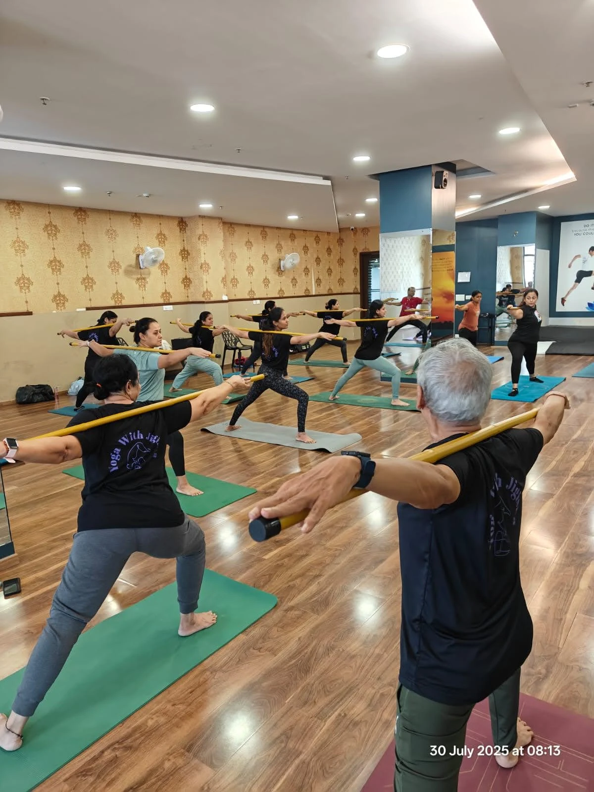 Stick Yoga Flexibility Focus - Student demonstrating deep stretches enhanced by stick support